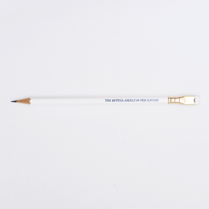 white pencil sharpened on a white background with pencil barrel text in blue that says 'THE BETTER ANGELS OF OUR NATURE'.