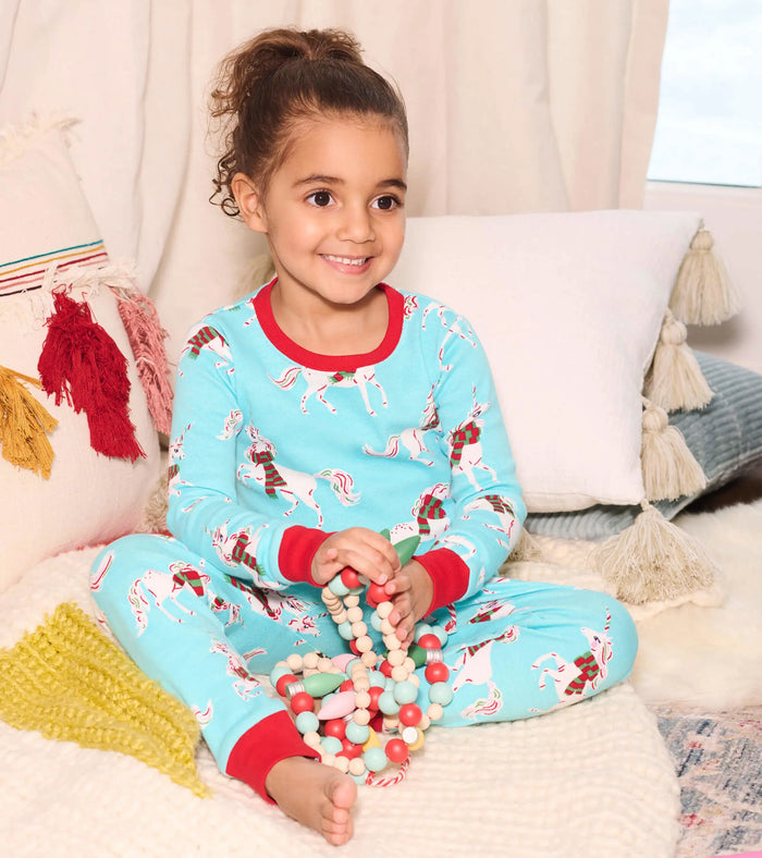 Girl wearing Hatley Christmas Unicorns pajamas with soft organic cotton and snug-fitting comfort.