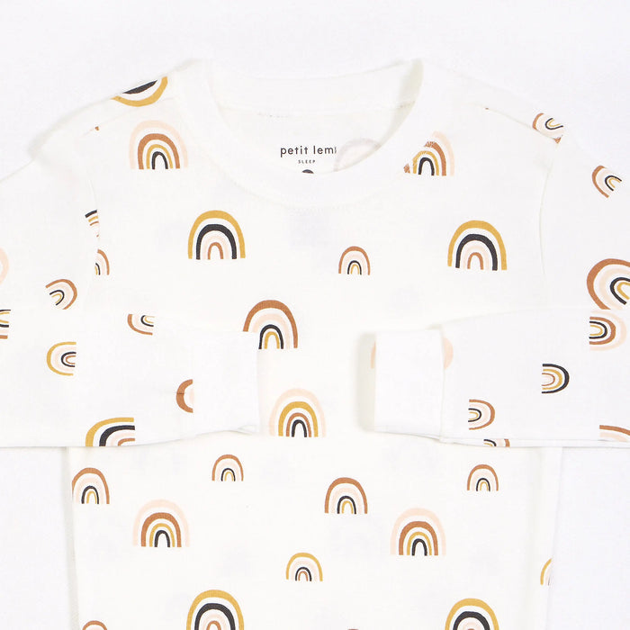 Closeup of Petit Lem girls Rainbows pajama top showing neutral rainbow print and rounded neckline.