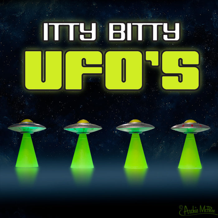 Four glowing, soft vinyl Itty Bitty UFOs float under the ITTY BITTY UFOS logo, set against a starry space backdrop.