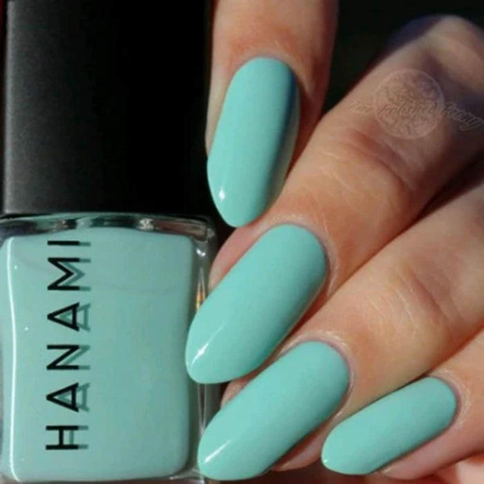 Mint green nail polish with 'HANAMI' branding and matching nails.