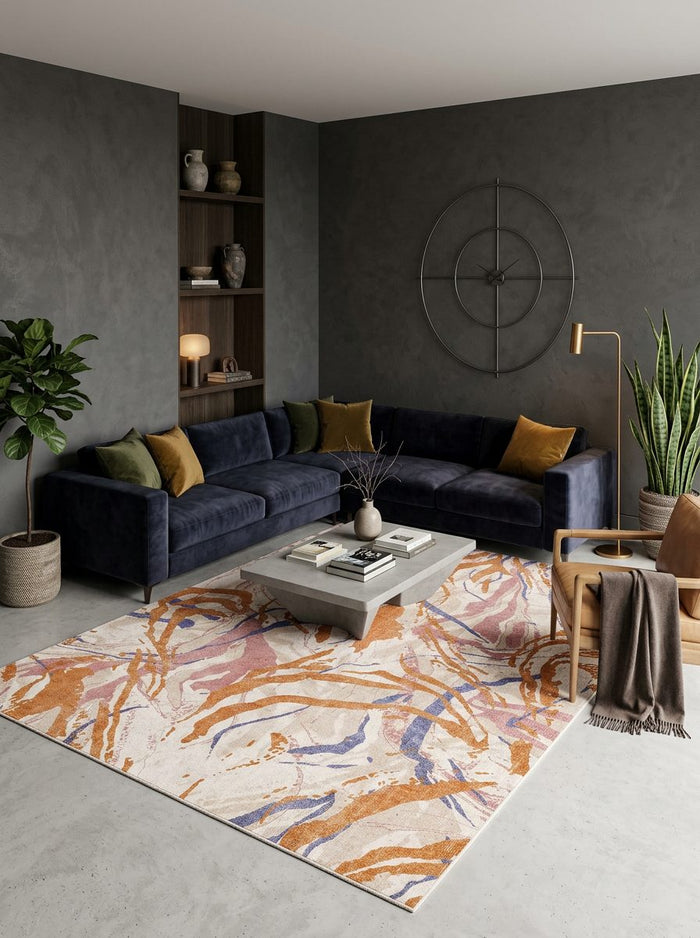 Cream rug with abstract orange, pink, and blue brushstroke patterns, styled in a modern living room.