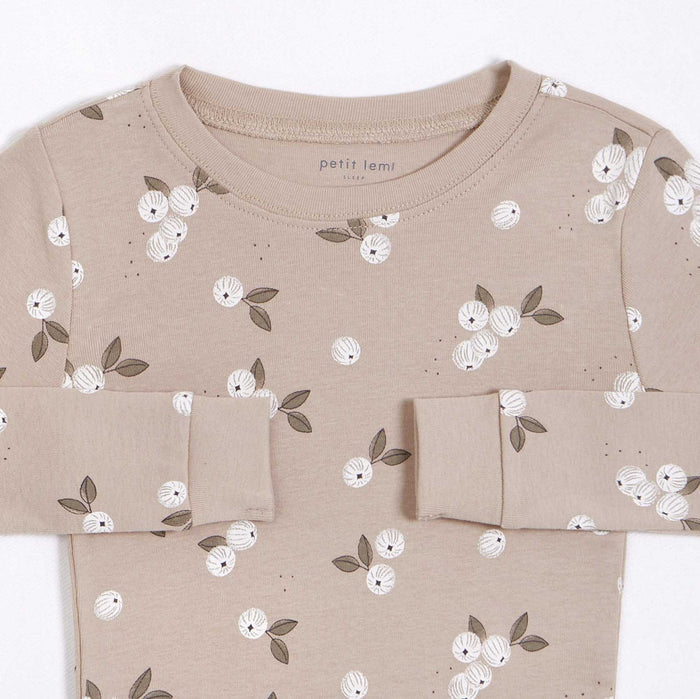 Closeup of Petit Lem girls Gooseberry pajama top showing rounded neckline and delicate white botanical print.