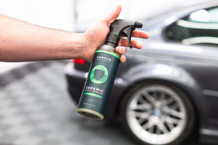 Armour Detail Ceramic 16oz bottle in front of a grey m3.