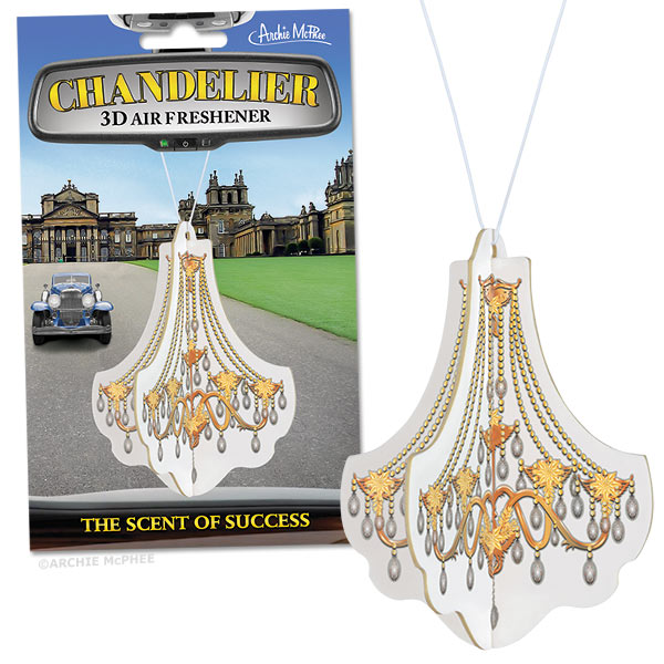 The Chandelier Deluxe 3D Air Freshener, set against a historic building backdrop and aptly captioned "Smells Like Success," exudes a luxurious essence. It is ideal for those looking to add a touch of opulence to their surroundings.