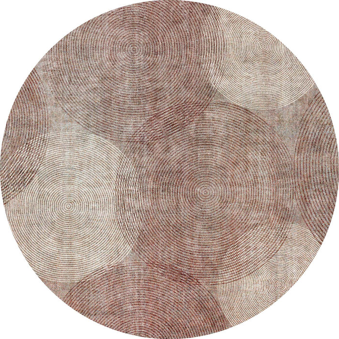 Round rug with overlapping concentric circle patterns in shades of brown, rust, and cream.