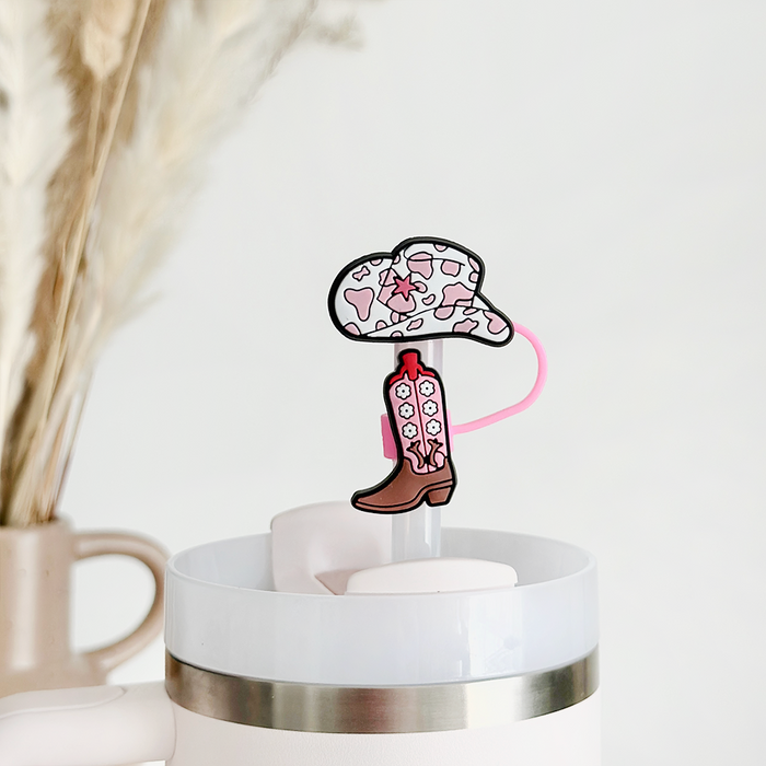 Coconut Lane Cowgirl Core straw cover with pink and white cowboy hat and boot, both accented with hearts, on a white cup.