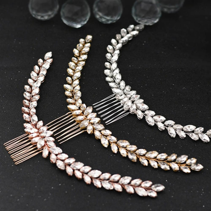 Three decorative hair combs in rose gold, gold, and silver with leaf-shaped crystals on a black surface, glass beads shimmering.