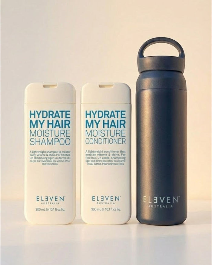 Set of 'Eleven Australia' hair care products including shampoo, conditioner, and a water bottle on a light background - Hair Care Canada