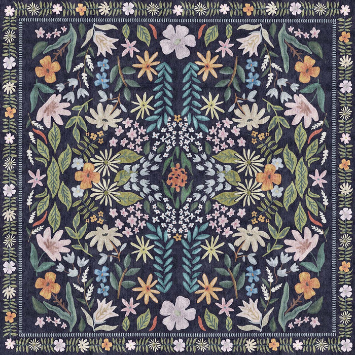 Navy blue rug with a symmetrical floral pattern in muted pink, yellow, and green, featuring a decorative leaf border.