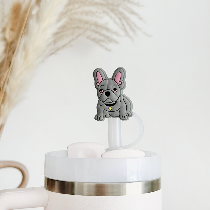 Blue Frenchie straw cover by Coconut Lane on a white tumbler, with pampas grass in the background.
