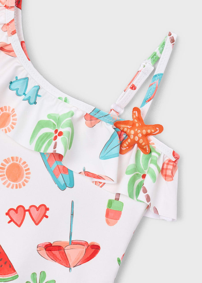Closeup of Mayoral girls swimsuit showing colorful print, bow detail, and stretch swim fabric.