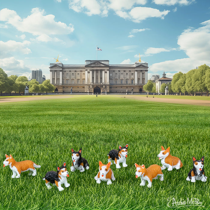 The adorable Itty Bitty Corgis are resting on the grass with a majestic palace behind them, set against a backdrop of a clear blue sky.