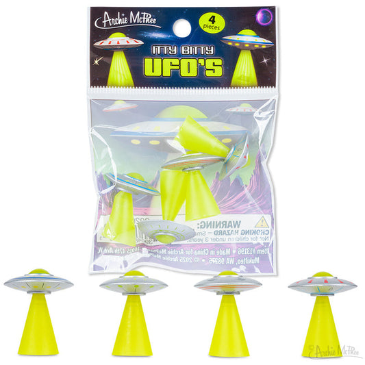 Four small soft vinyl UFOs, each with a green beam, displayed beneath a clear package labeled “Itty Bitty UFOs.”.