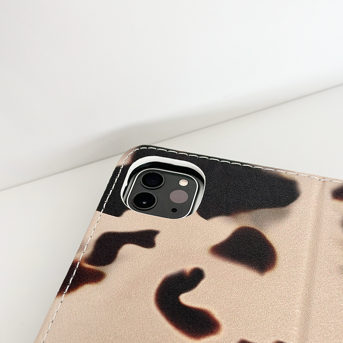 Ivory tortoiseshell-pattern vegan leather iPad case with a close-up of the precise camera cutout.