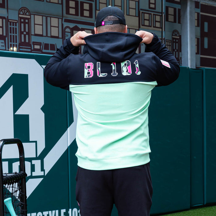 Adult model wearing teal quarter zip hoodie with "King Of JUCO" design
