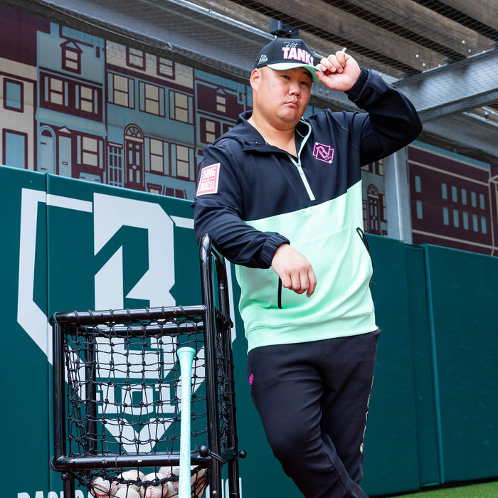 Adult model wearing teal quarter zip hoodie with "King Of JUCO" design