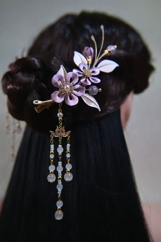 Lavender Handmade Chanhua hair clips with tassel on dark hair