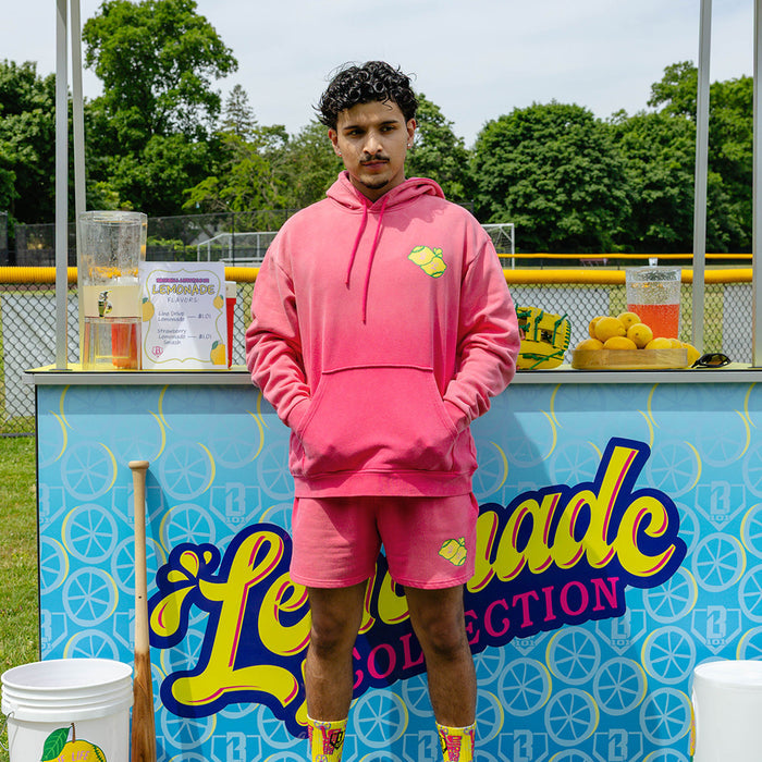 Adult model wearing pink hoodie with "Lemon Dingers" design