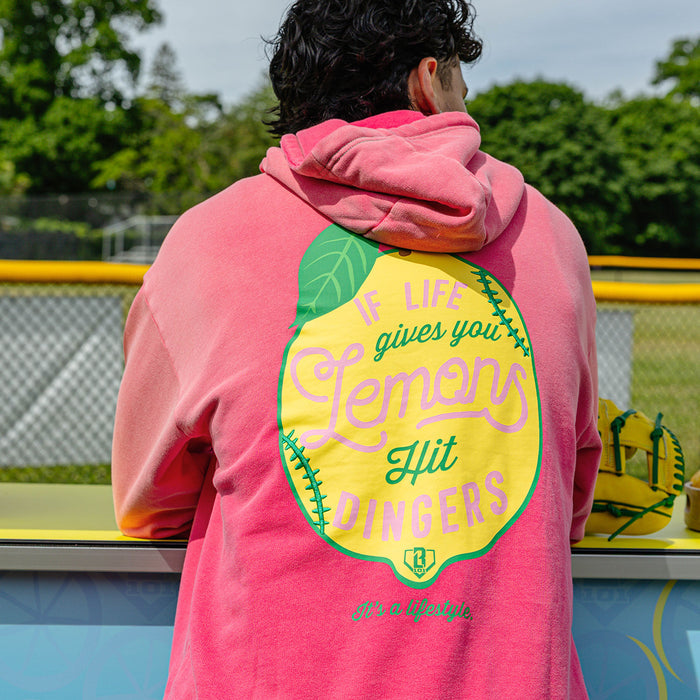 Adult model wearing pink hoodie with "Lemon Dingers" design