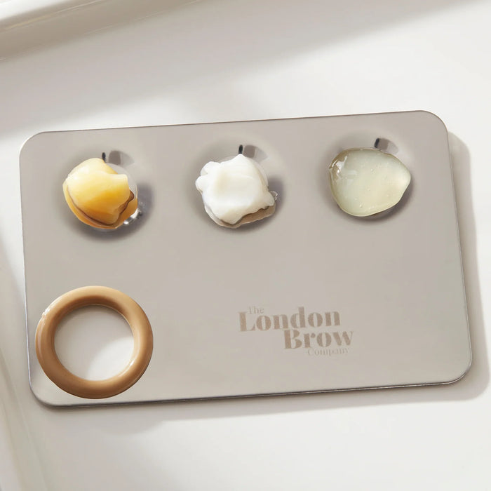 Set of eyebrow products on a tray with 'The London Brow' branding.