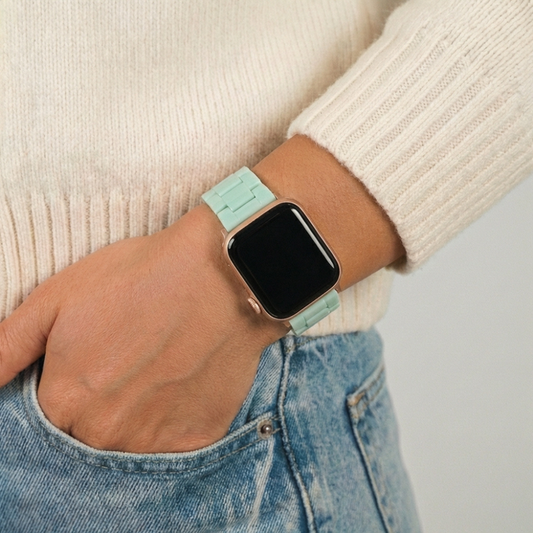 Pastel mint Apple Watch strap by Coconut Lane, shown on a wrist with a cream sweater and blue jeans.