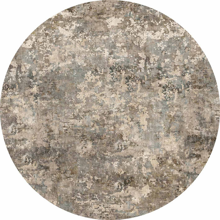 Round rug with a distressed, abstract mottled pattern in shades of grey, beige, and muted blue.