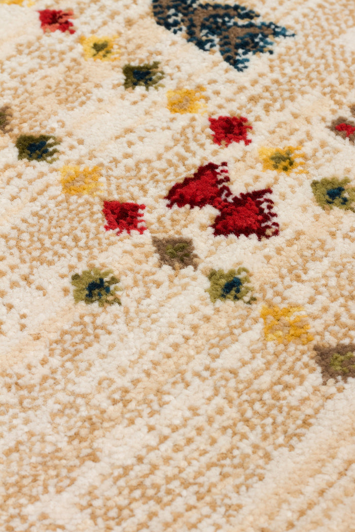Cream-colored high-pile rug with a scattered pattern of small red, yellow, blue, and green geometric motifs.