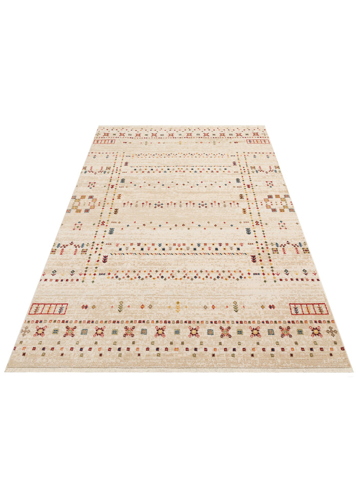 Cream area rug with a distressed finish, featuring multicolored geometric tribal motifs and a fringed edge.