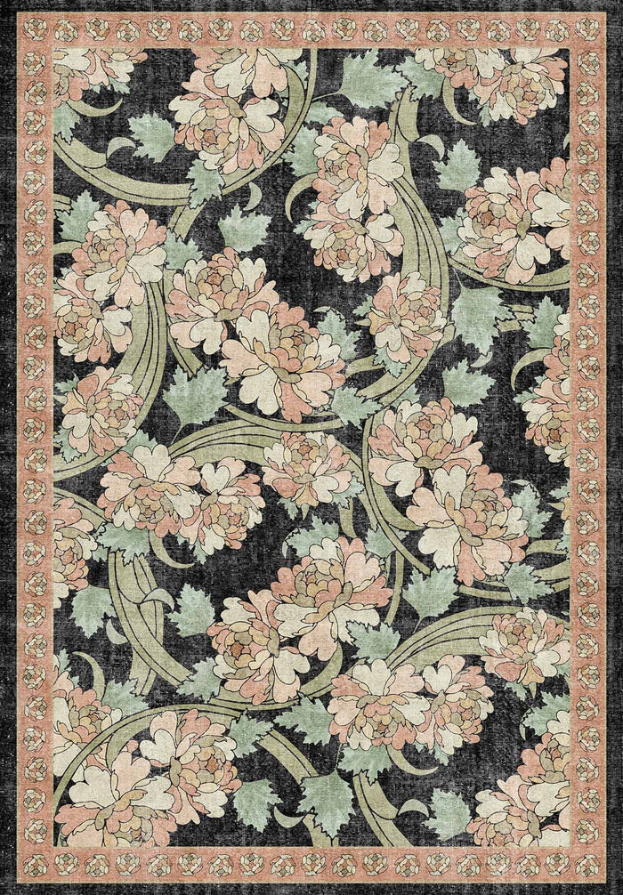 Black rug with a pink and sage green floral pattern and a decorative border.