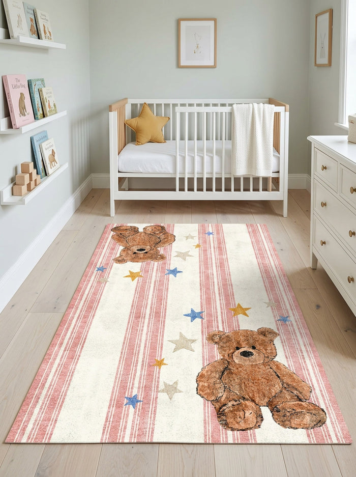 Cream rug with pink stripes, teddy bear motifs, and scattered stars, styled in a nursery.