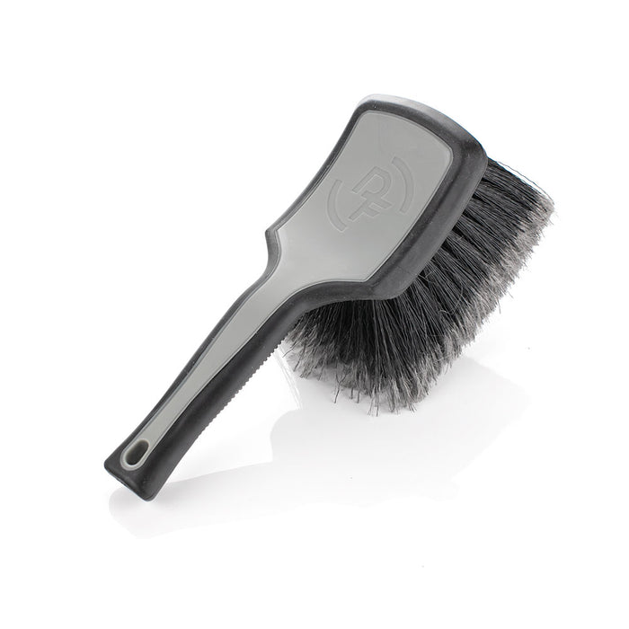 A grey Detail Factory Wheel Face brush on a white background.