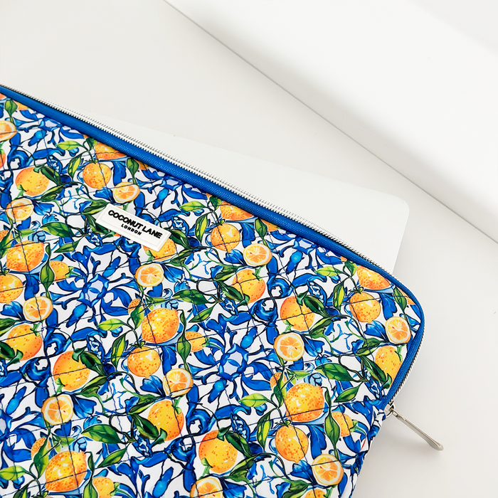 Coconut Lane lemon-patterned quilted laptop sleeve with blue zipper on a white surface.