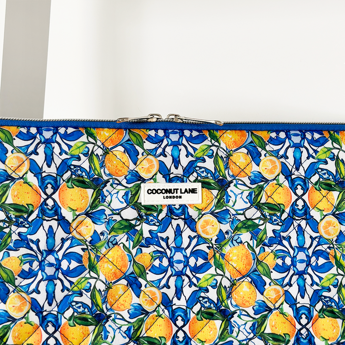 Quilted Coconut Lane laptop sleeve with blue and yellow lemon pattern on a white background.
