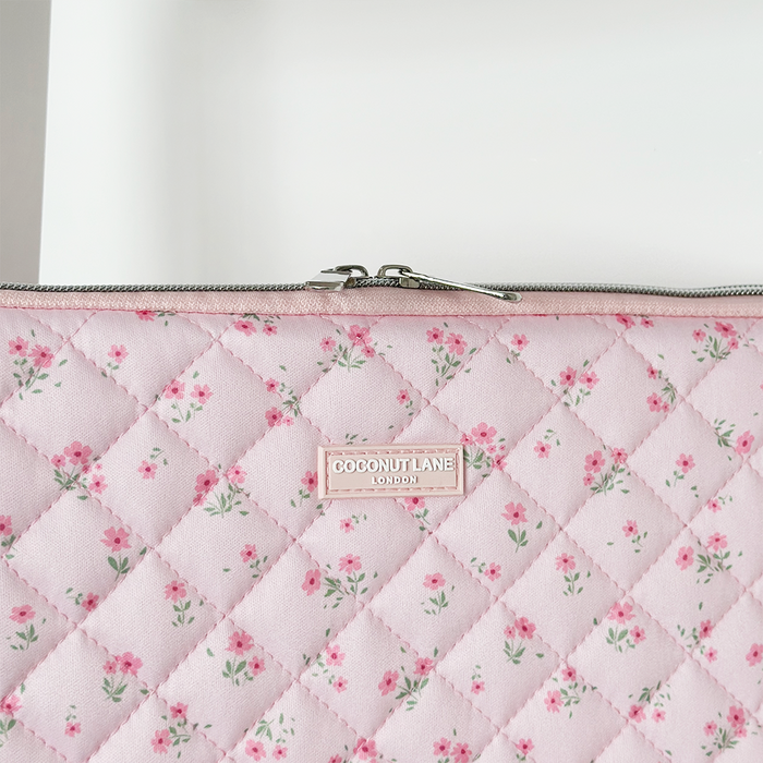 Pink quilted laptop sleeve with ditsy floral pattern from Coconut Lane.