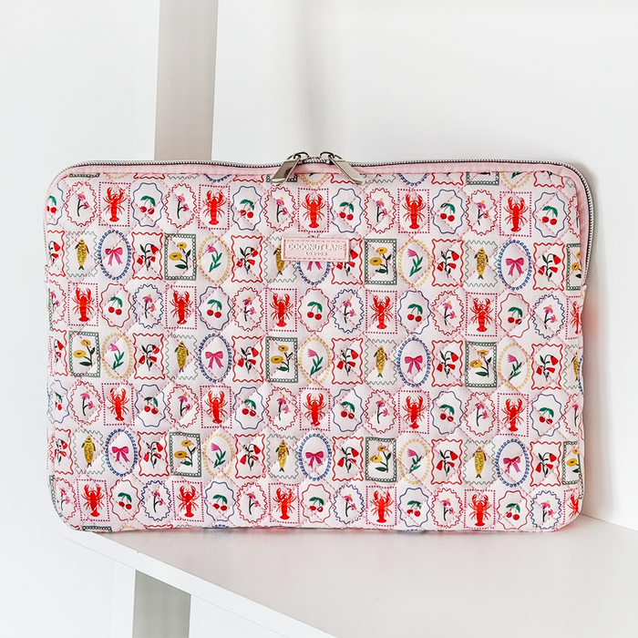 Quilted Coconut Lane laptop sleeve with a colorful pattern of lobsters, fish, and flowers.
