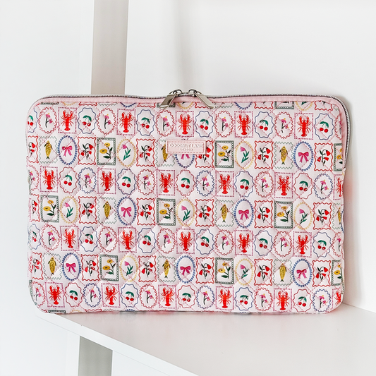 Quilted Coconut Lane laptop sleeve with a colorful pattern of lobsters, fish, and flowers.