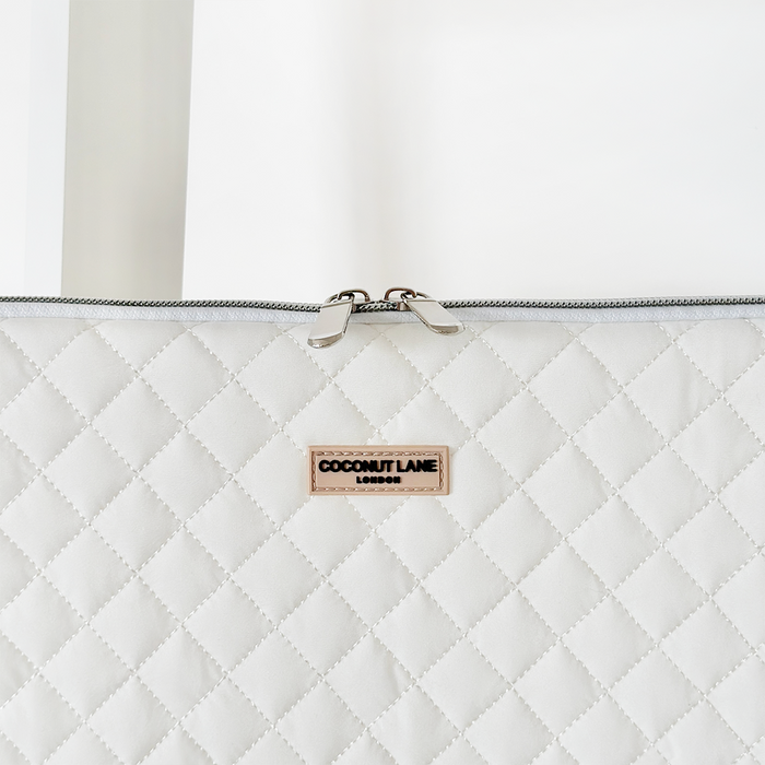White quilted laptop sleeve with a subtle coconut pattern and smooth finish from Coconut Lane.
