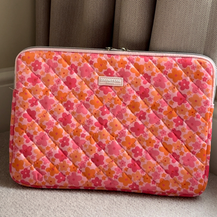 Coconut Lane pink and orange quilted laptop sleeve with floral pattern.