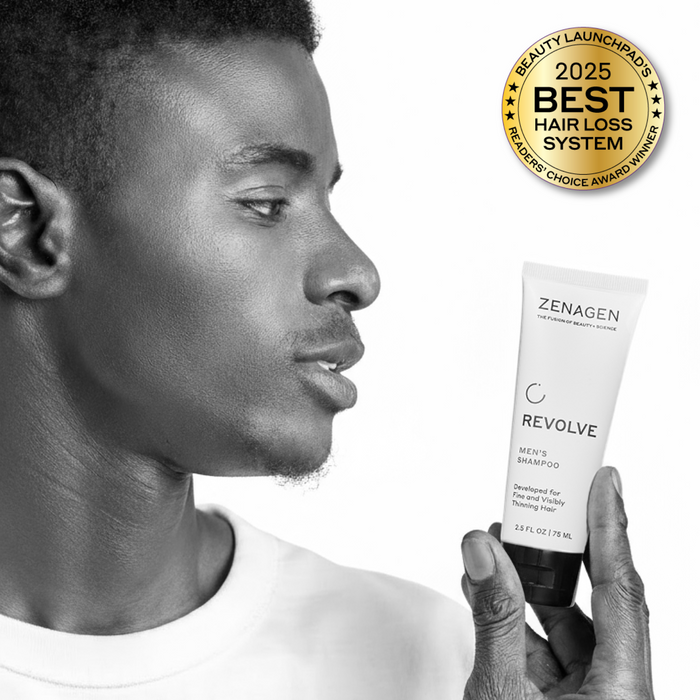 Man holding Zenagen Revolve Men’s Shampoo travel size, professional hair care product for thinning hair appearance.