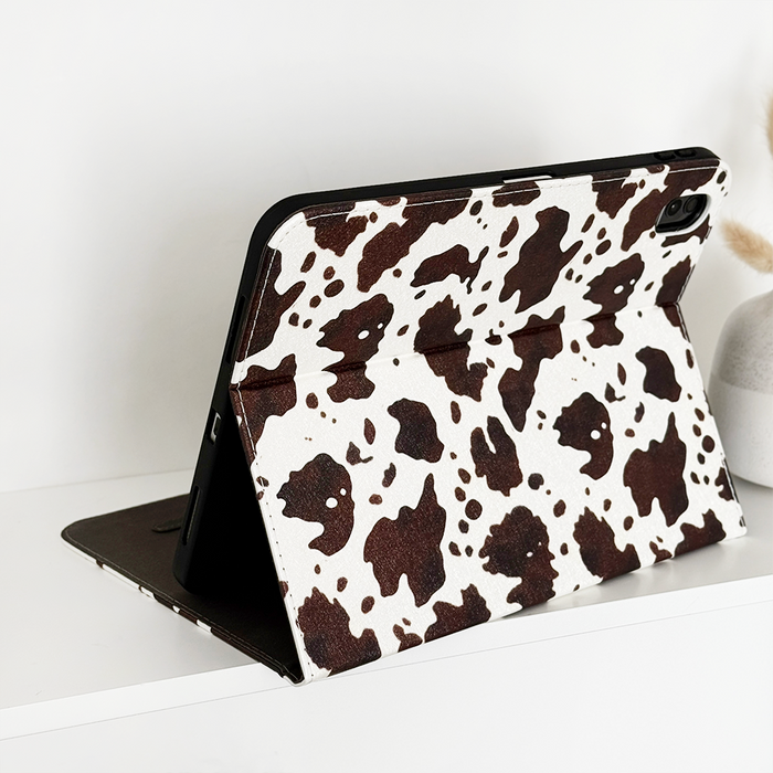 Rodeo Cowgirl iPad case with a playful western pattern, shown next to a light-colored vase.