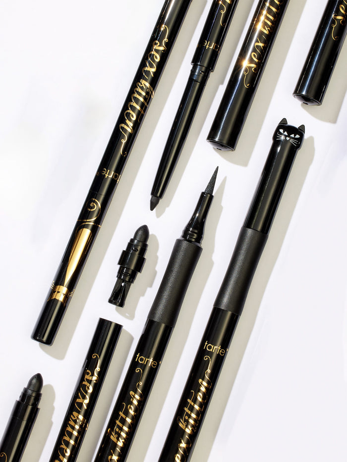 Collection of black eyeliner pens with visible branding on a white background