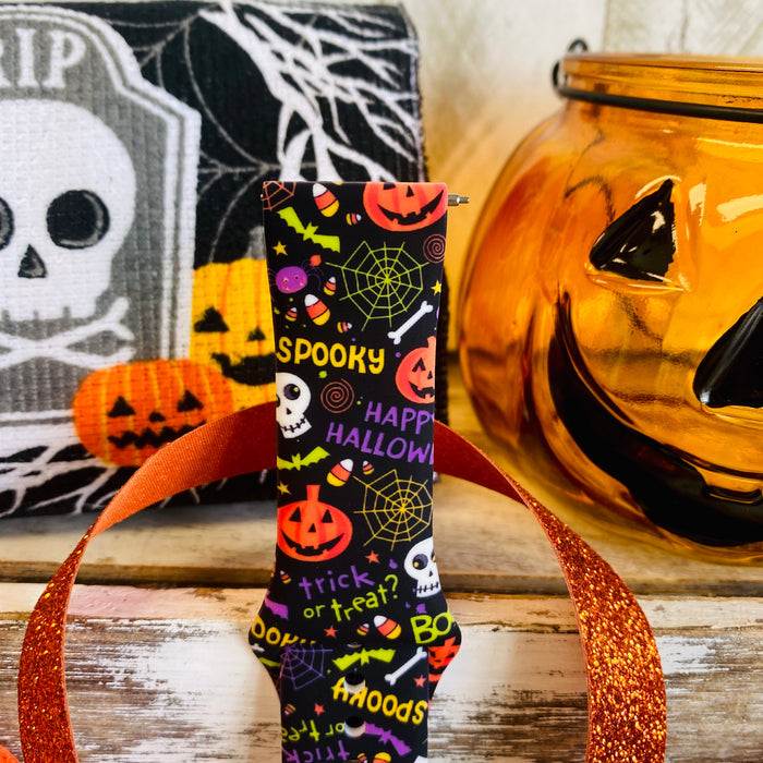 Close-up of the Spooky Samsung Galaxy Watch band showing the white skull, HAPPY HALLOWEEN lettering and spiderweb detail.