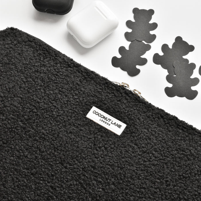 Black textured laptop sleeve with bear-shaped cutouts, shown alongside matching cases.