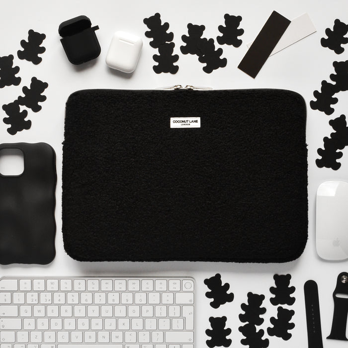 Brown Teddy Baloo laptop sleeve on a white desk with tech accessories and black teddy bear cutouts.