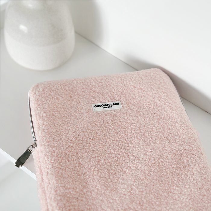 Pink Teddy Love-A-Lot iPad sleeve with bear design next to a white vase on a white surface.