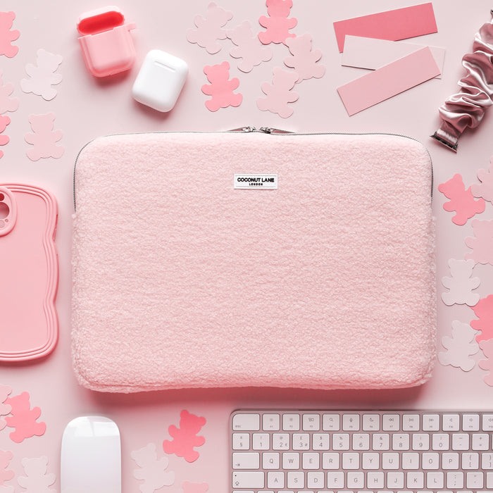 Coconut Lane Teddy Love-a-Lot laptop sleeve with pink bear design on a desk, surrounded by pink accessories and keyboard.