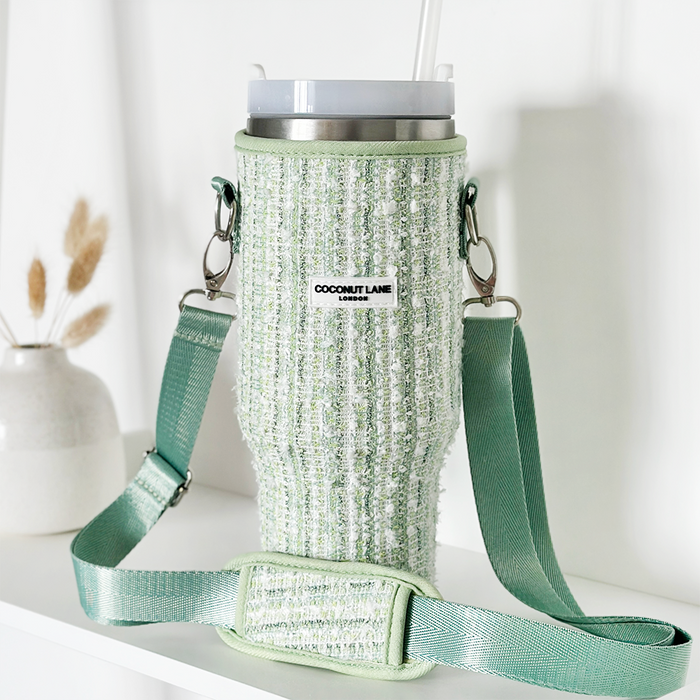 Matcha green textured tweed tumbler carry case with strap, holding a tumbler and straw on a white surface.
