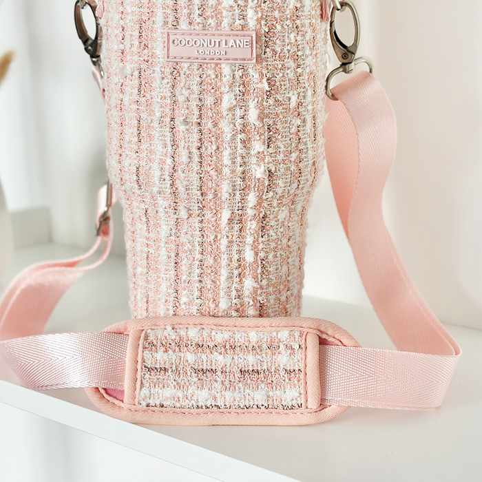 Pink tweed Coconut Lane tumbler carry case with wide adjustable pink shoulder strap, shown in close-up.