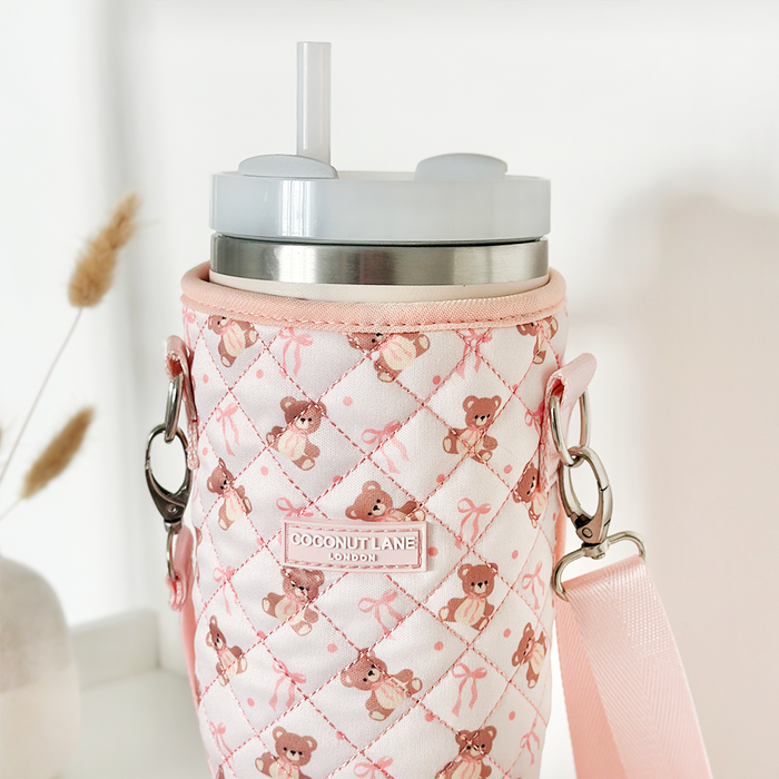 Stanley Quencher 40oz with straw in a pink quilted carry case patterned with bears and bows.